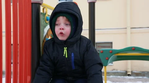 A boy on the playground in winter Stock Footage 166643382
