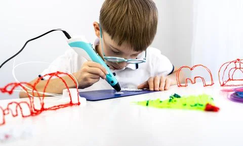 Boy playing with a 3D pen 스톡 사진