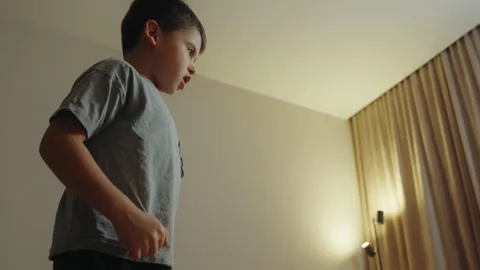 Boy playing alone at home, gesturing and talking to himself. Young preschool kid 스톡 동영상 261974744