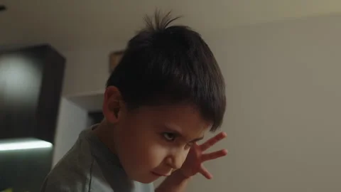 Boy playing alone, shouting outrageously and gesticulating with his hands in the Stock Footage 261974907