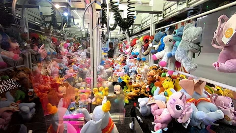 Boy playing with a amusement machine with hook, catches stuffed animal, pov Stock Footage 198891904