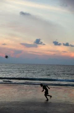Boy playing and sunset Stock Photos