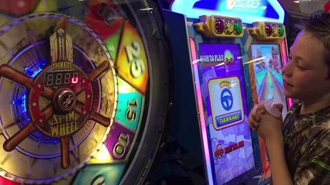 Boy playing arcade game for tickets HD Stock-Footage 73339480
