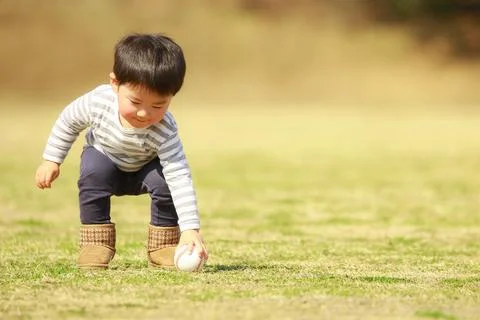 Boy playing with a ball Stock Photos