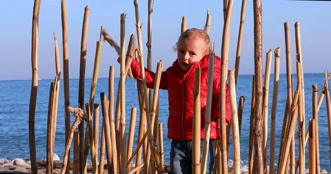 Boy Playing With A Bamboo Stick On Beach Alone 스톡 동영상 122258904
