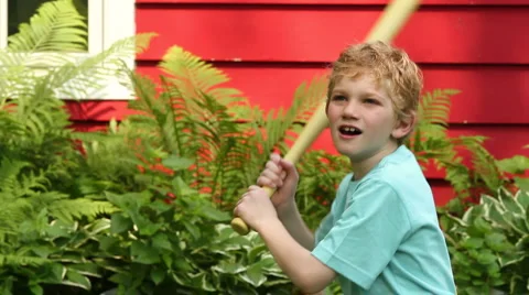 Boy playing baseball in the backyard, close up Stock Footage 6108657