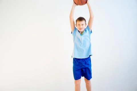 Boy playing basketball Stock Photos