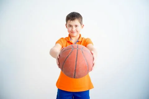 Boy playing basketball Stock Photos