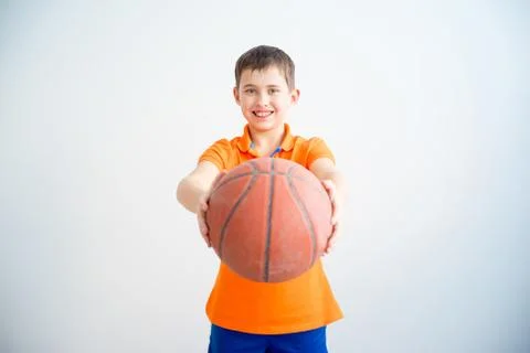 Boy playing basketball Stock Photos