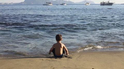 Boy playing on the beach Stock Footage 1067526