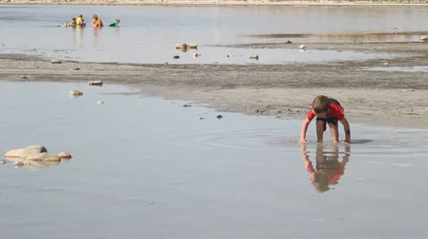 Boy playing on beach Stock Footage 27063256