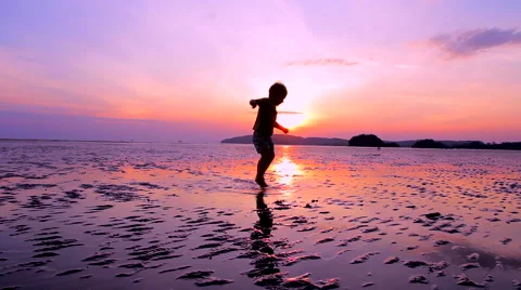 Boy playing at the beach Stock Footage 64213225