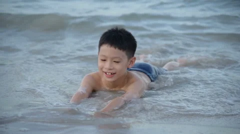 Boy playing at the beach Stock Footage 67302059