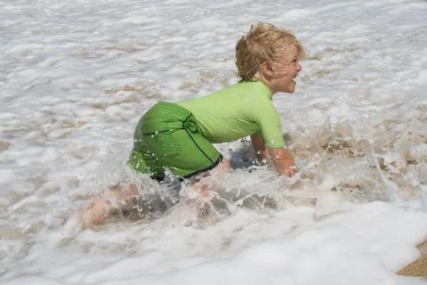 Boy is playing at the beach Stock Photos