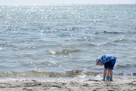 Boy playing at the beach Stock Photos