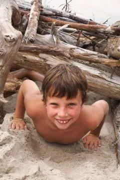 Boy Playing on Beach Stock Photos