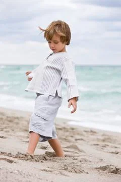 Boy playing on the beach Stock Photos