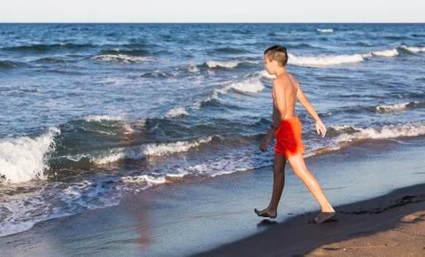 Boy playing on the beach Stock Photos
