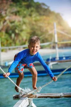 Boy playing at the beach. Photos