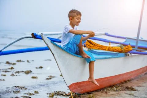 Boy playing at the beach. Stock Photos