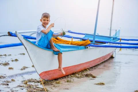Boy playing at the beach. 写真素材