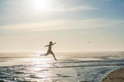 Boy playing at beach Stock Photos