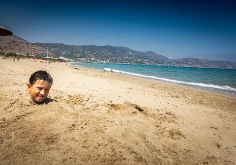 Boy playing at beach Stock Photos