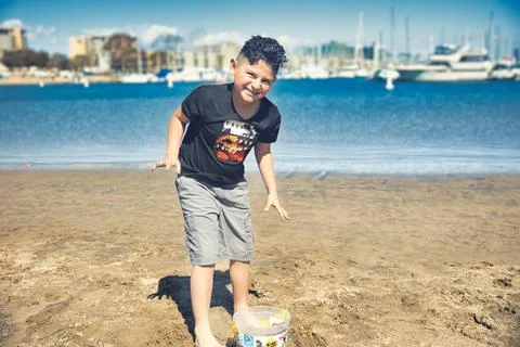 A boy playing on the beach in Venice Beach, CA Stock Photos