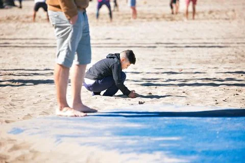A boy playing on the beach in Venice Beach, CA Stock Photos