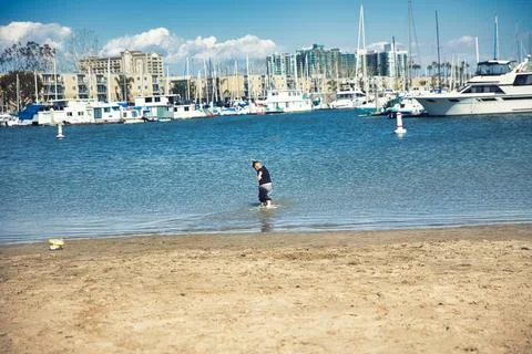 A boy playing on the beach in Venice Beach, CA Stock Photos