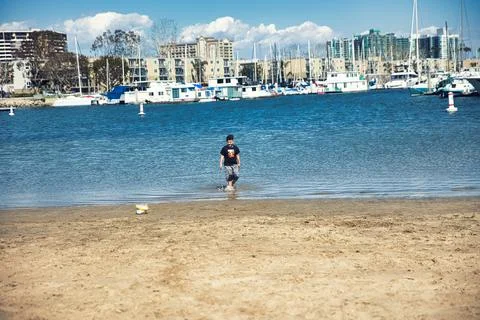 A boy playing on the beach in Venice Beach, CA Stock Photos