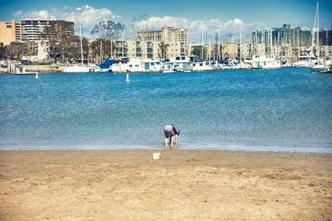 A boy playing on the beach in Venice Beach, CA Stock Photos