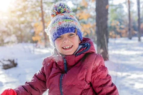 Boy playing in big snow in winter. Photos