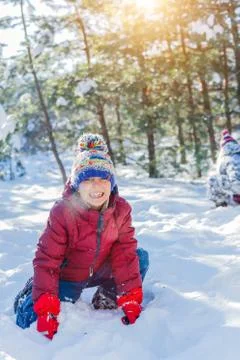 Boy playing in big snow in winter. Photos