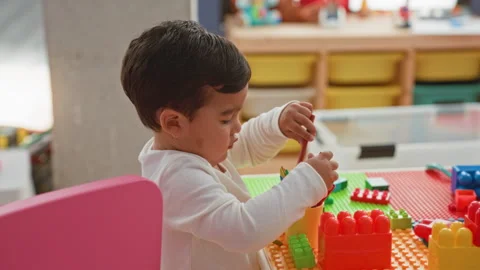 Boy playing with blocks, hands holding crayons and stacking plastic bricks .. Stock Footage 339185837