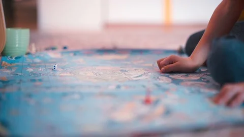 A boy is playing a board game. Видео 120736434