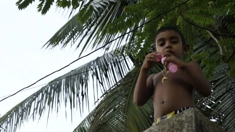 Boy playing with bubble wand Video stock 71564324