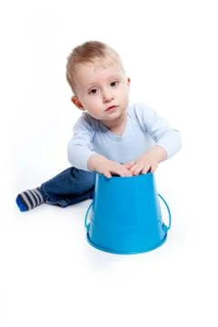 Boy playing with a bucket Stock Photos