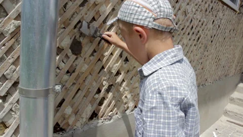 Boy playing builder Stock Footage 178851399