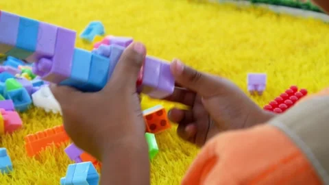 Boy playing building blocks. educational concept to train creativity Stock Footage 310245447