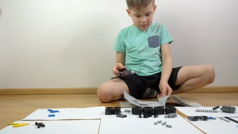Boy playing with building blocks. Small engineer genius constructing  Stock Footage 125485633