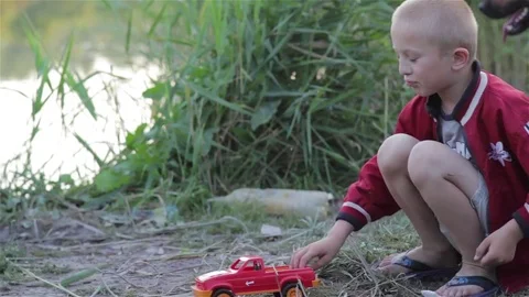 Boy playing in a car in the nature Stock Footage 78809034