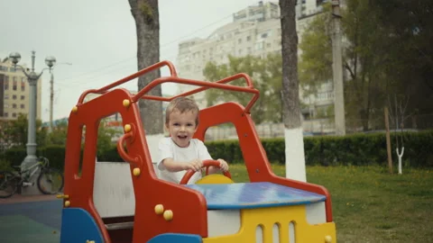 Boy playing in the car on the playground. Stockbeeldmateriaal 89944227