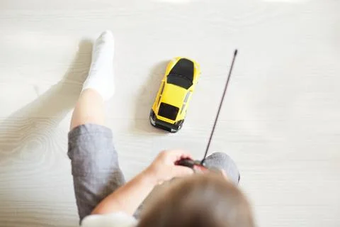 A boy playing with a car remote Stock Photos