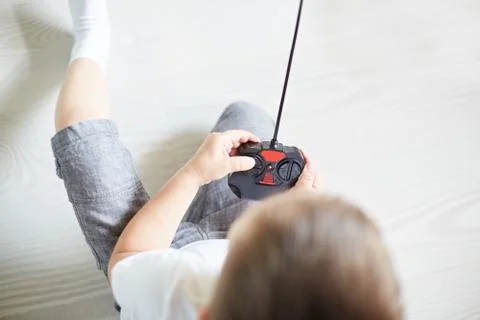 A boy playing with a car remote Stock Photos