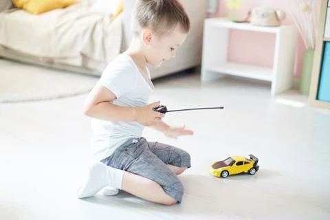 A boy playing with a car remote Stock Photos