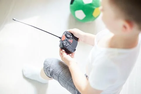 A boy playing with a car remote Stock Photos