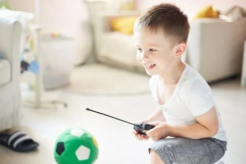 A boy playing with a car remote Stock Photos