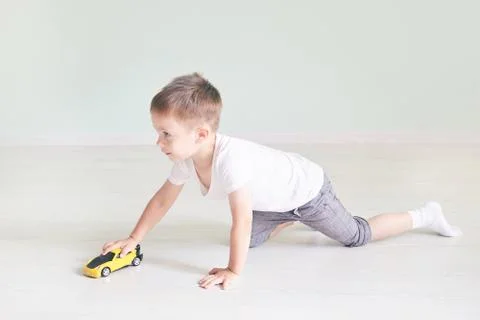 A boy playing with a car remote Stock Photos