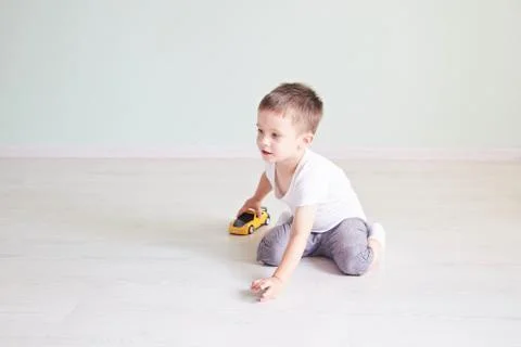 A boy playing with a car remote Stock Photos